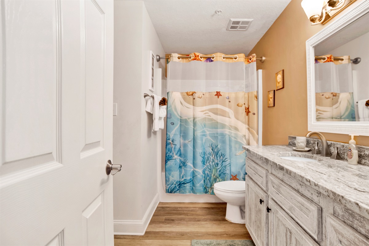 Main bathroom with a tub/shower combo and extra long vanity with granite top. This bathroom has 2 doors, 1 goes directly into the 2nd bedroom and the other goes in to the living area