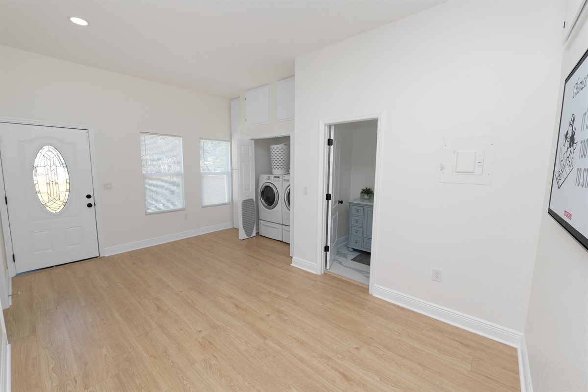 Skip the laundromat! This private laundry closet offers full-size machines, a laundry basket, and all the essentials you need—just steps from the bathroom and bedrooms.