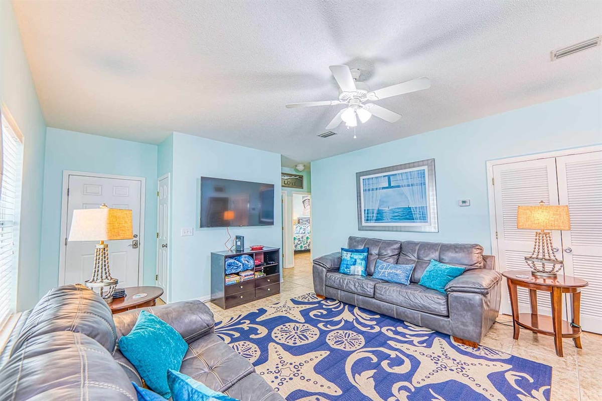 Living Room: Bright and airy space with beachy decor, perfect for relaxation after a sun-soaked day!