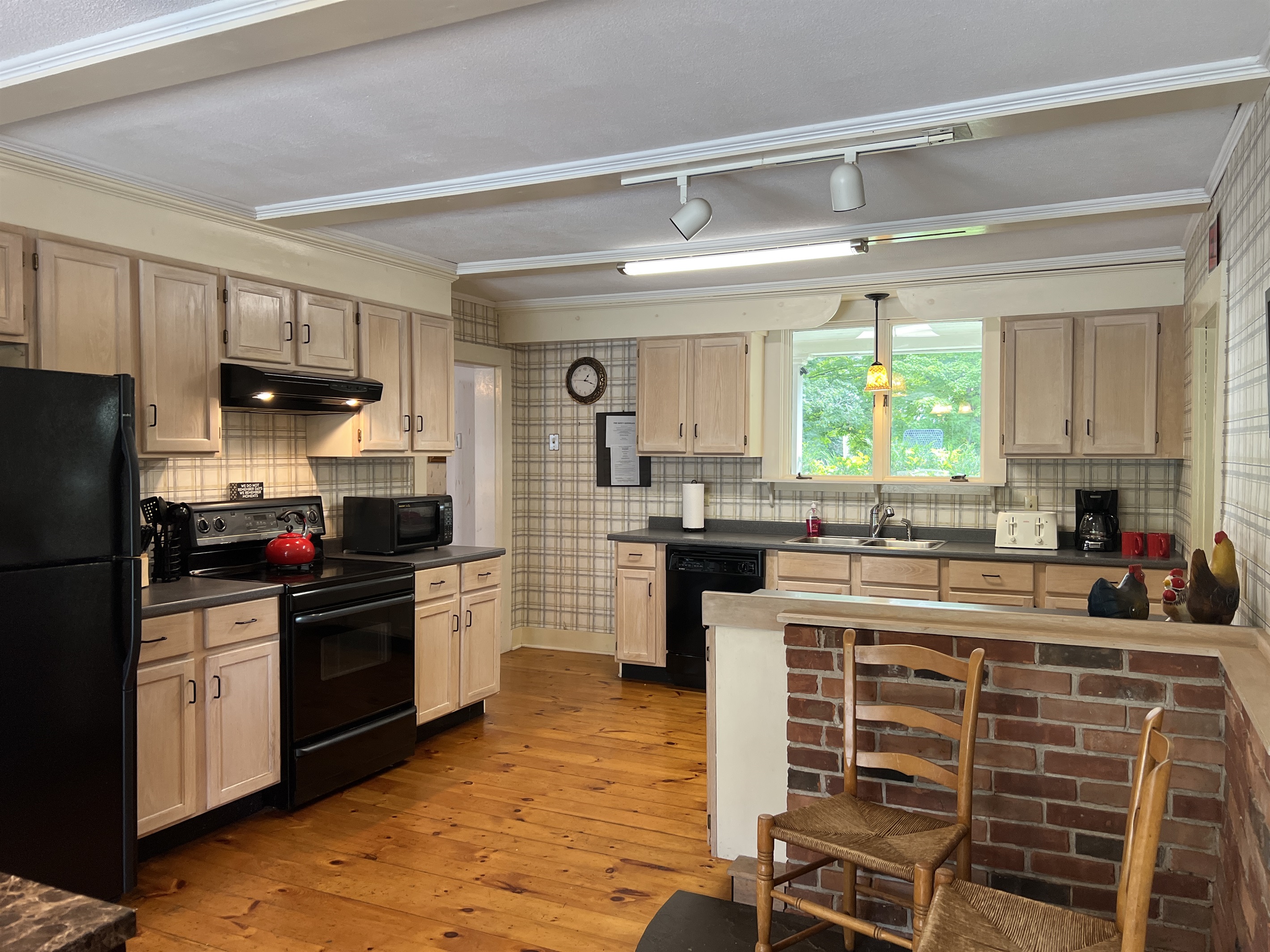 The Federal House Kitchen with Sliding doors leading to the deck, grill and pool area.