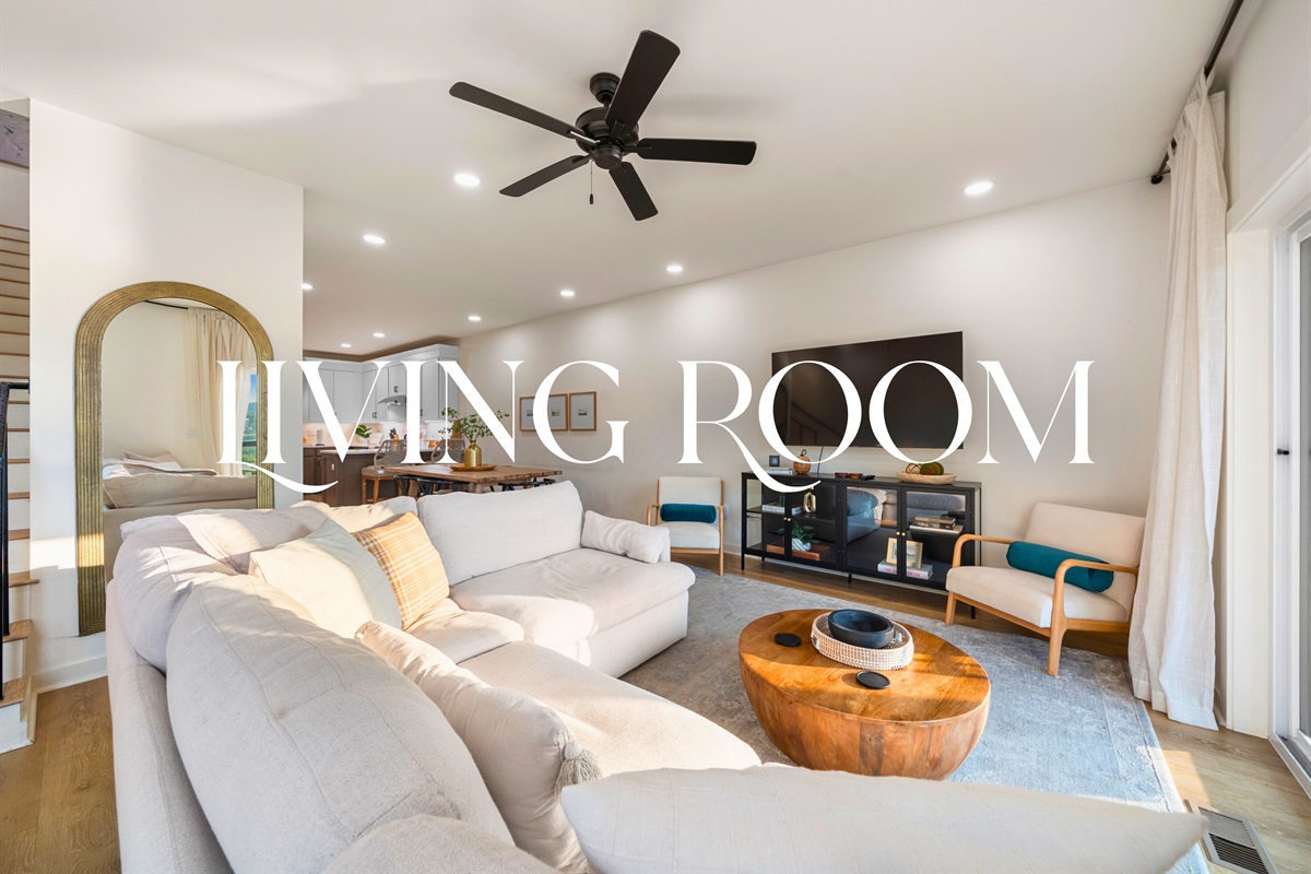 Comfortable living room with plush sectional, modern decor, and Smart TV for cozy evenings in.