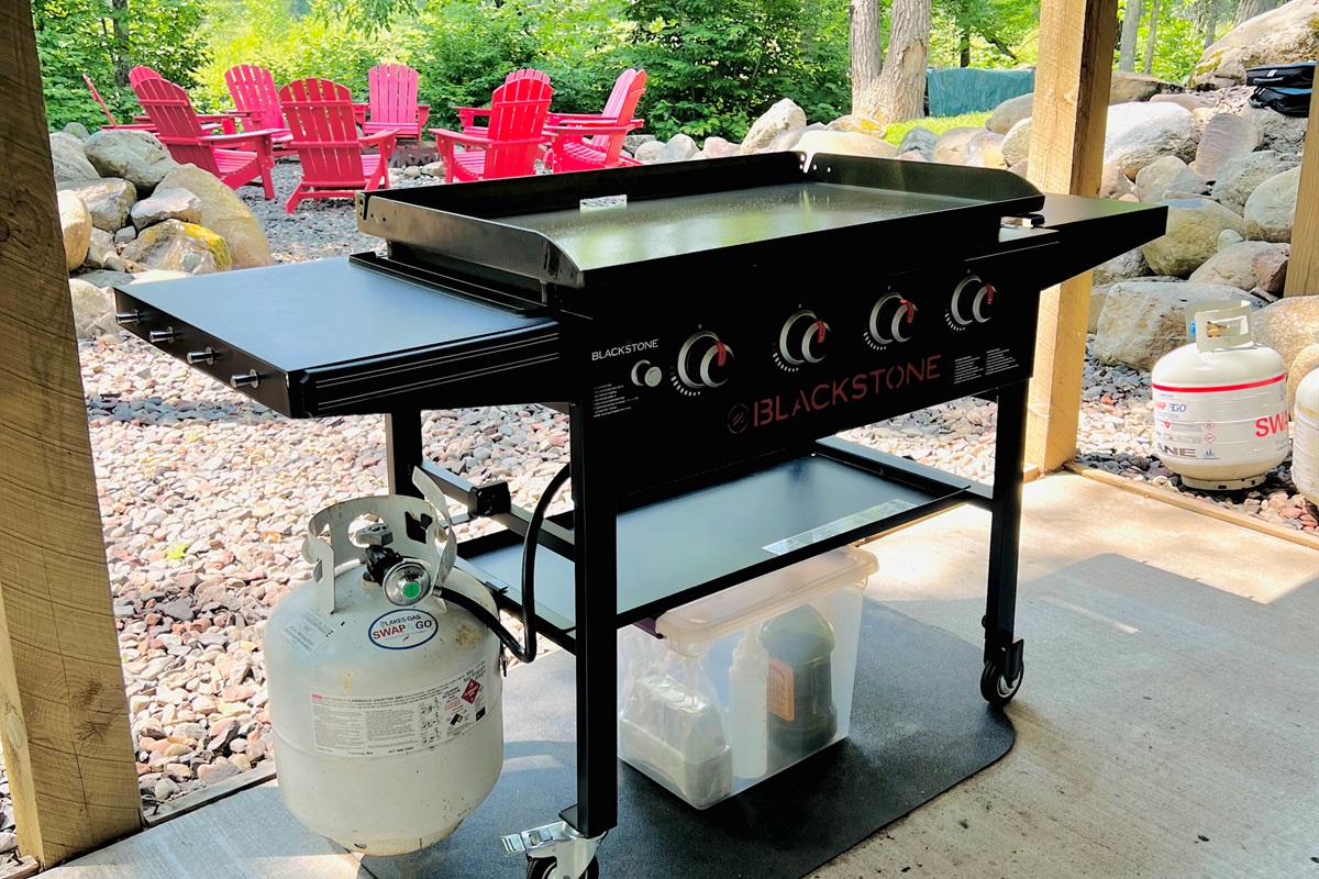 The Blackstone gas griddle is located on the lower level concrete patio facing the lake.