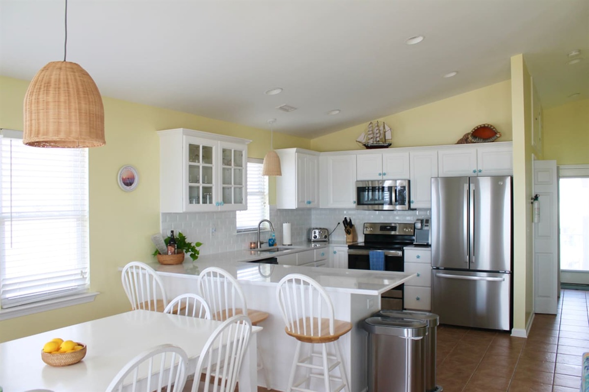 Updated countertops and stainless steel appliances. Fully stocked with cups and wine glasses, cookware, utensils, and baking needs. Three counter seats.