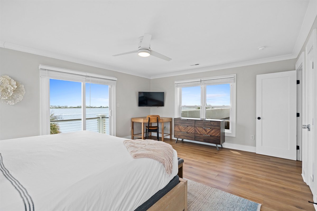 Private king bedroom with workspace, balcony access, and beautiful panoramic water views