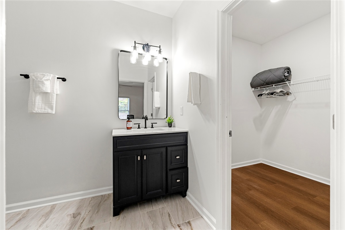 Modern bathroom stocked with fresh towels and everyday essentials.