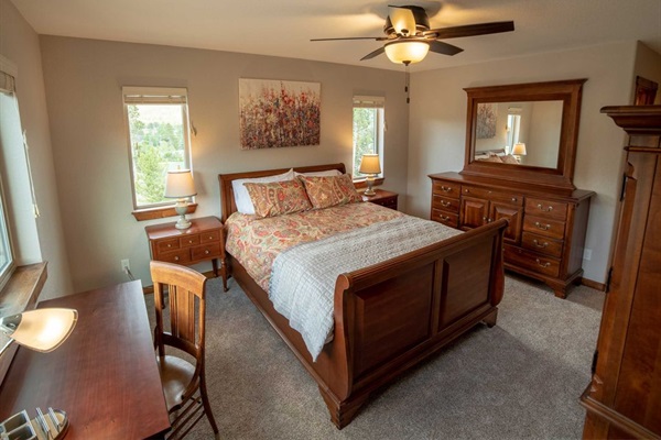 Upstairs Bedroom 3 Spacious queen bedroom featuring a dedicated work desk, ample storage, and elegant high-end furnishings—perfect for both relaxation and productivity during your stay!