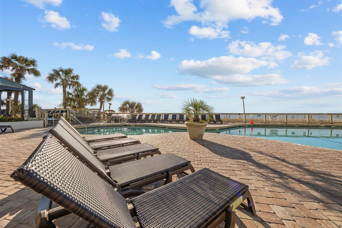 Relax poolside in the resort sun loungers 