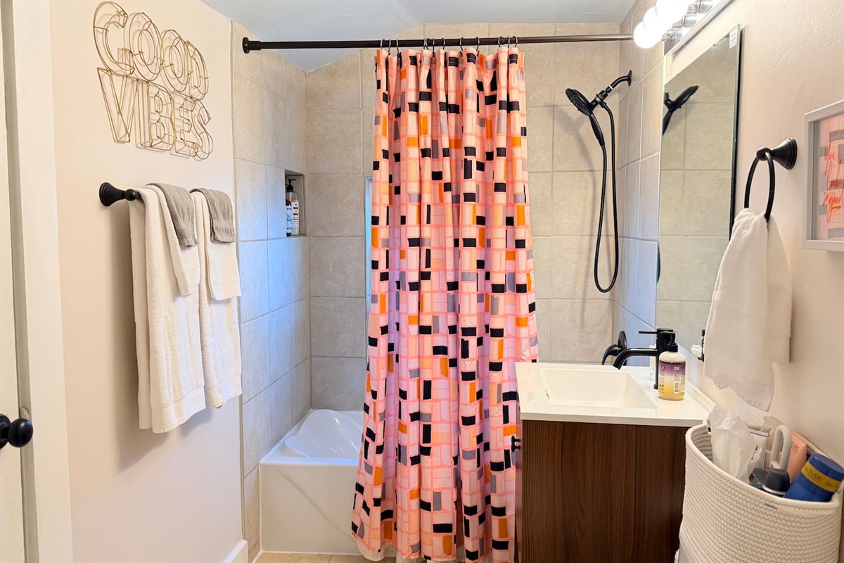 Full bathroom with shower + soaker tub, modern fixtures, soft cotton towels, bright lighting and bathroom essentials  - ideal for extended stays