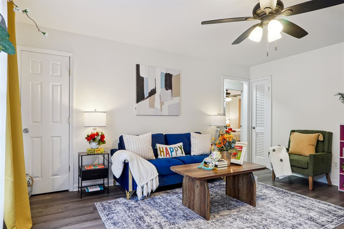 The living room features cozy furniture, including a comfortable blue couch, and an Amazon Fire-powered Smart TV for your entertainment. You’ll also find the Xfinity modem conveniently located here, convenient for ethernet connection.