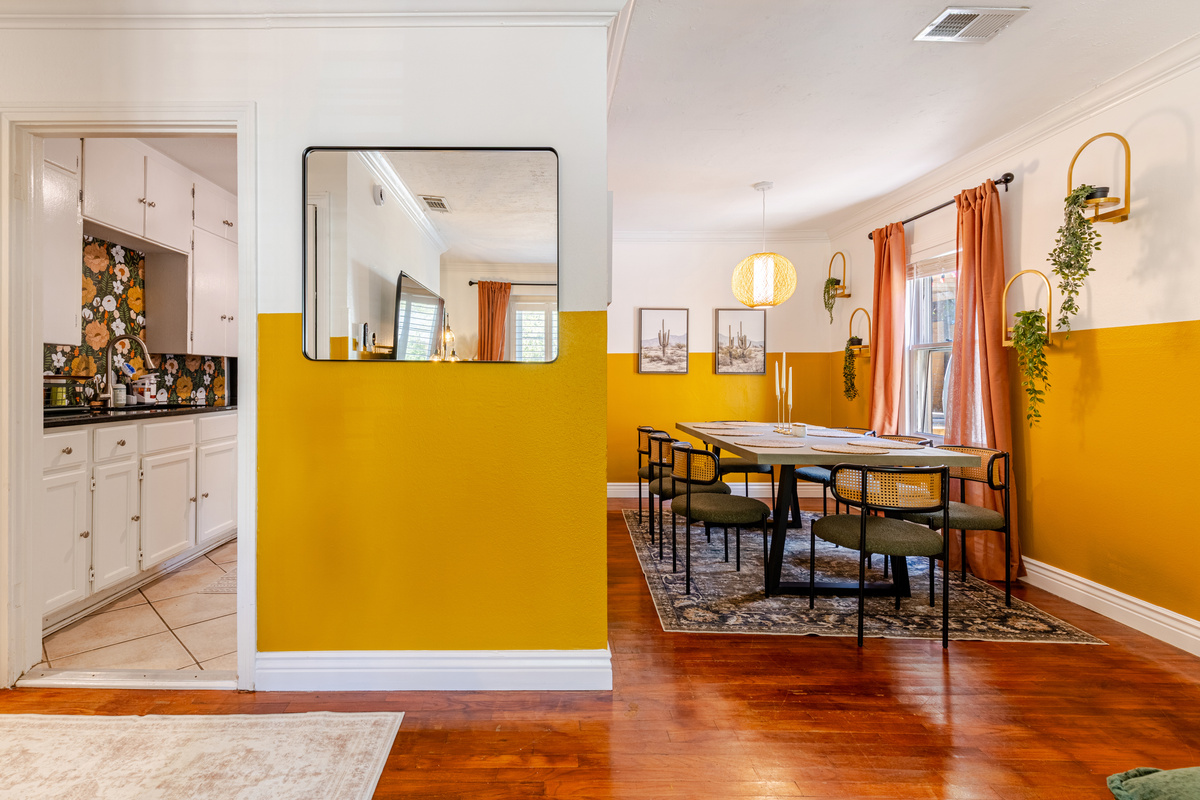 Bright yellow accents and a stylish table perfect for gathering and sharing meals!
