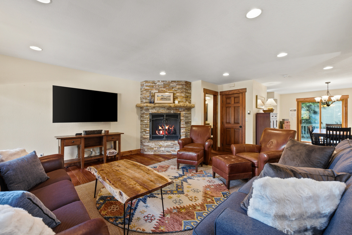 Spacious living room with half bathroom, game closet and dining seen in background. 