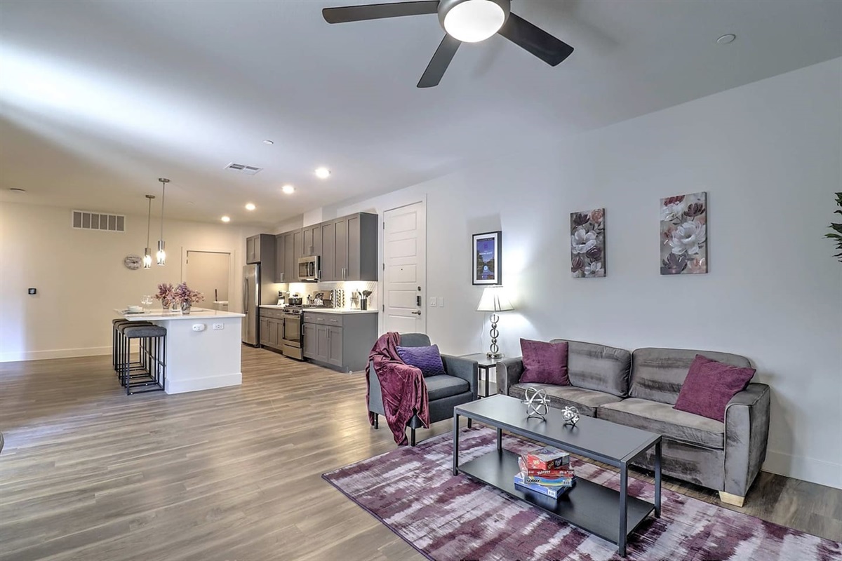 - Relax in an airy living room blending modern style and cozy comfort   - Open floor plan connects seamlessly to the elegant kitchen area   - A welcoming space for watching TV, reading, or sharing great moments