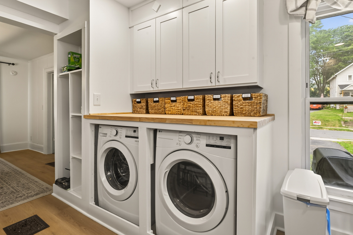 Washer and dryer beneath open shelving
