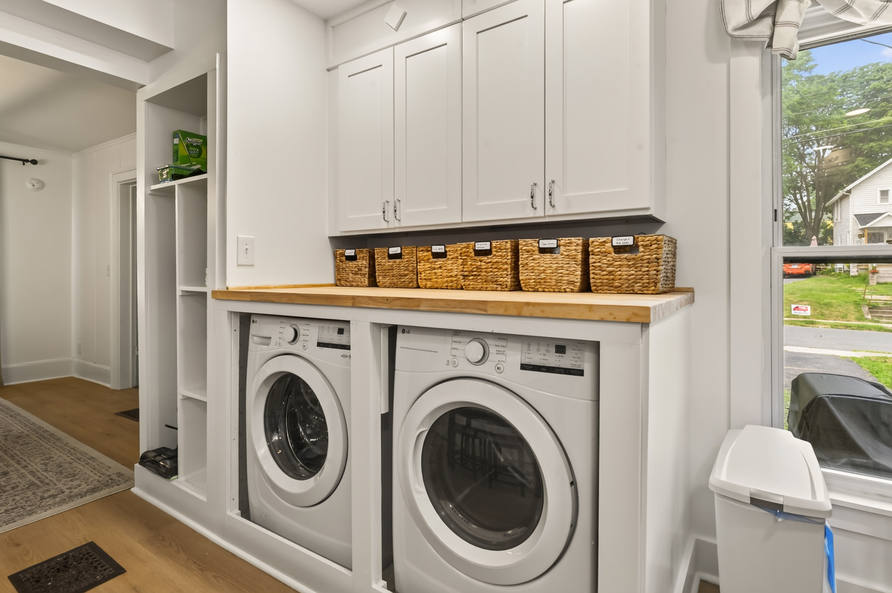 Washer and dryer beneath open shelving