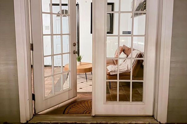 French doors open into a bright common area, adding charm and flexible space to this thoughtfully designed home.