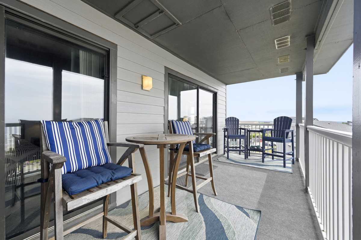 The balcony you'll never want to leave—complete with ocean views and overlooking the sparkling pool.