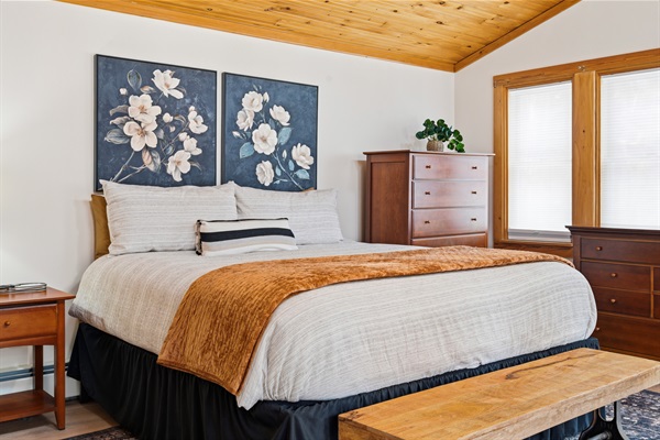 Experience the warmth of natural wood and plush textures in this bright, airy sanctuary just off the main living area.