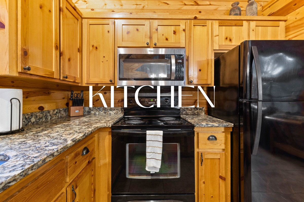 Fully equipped kitchen with granite counters and woodsy charm