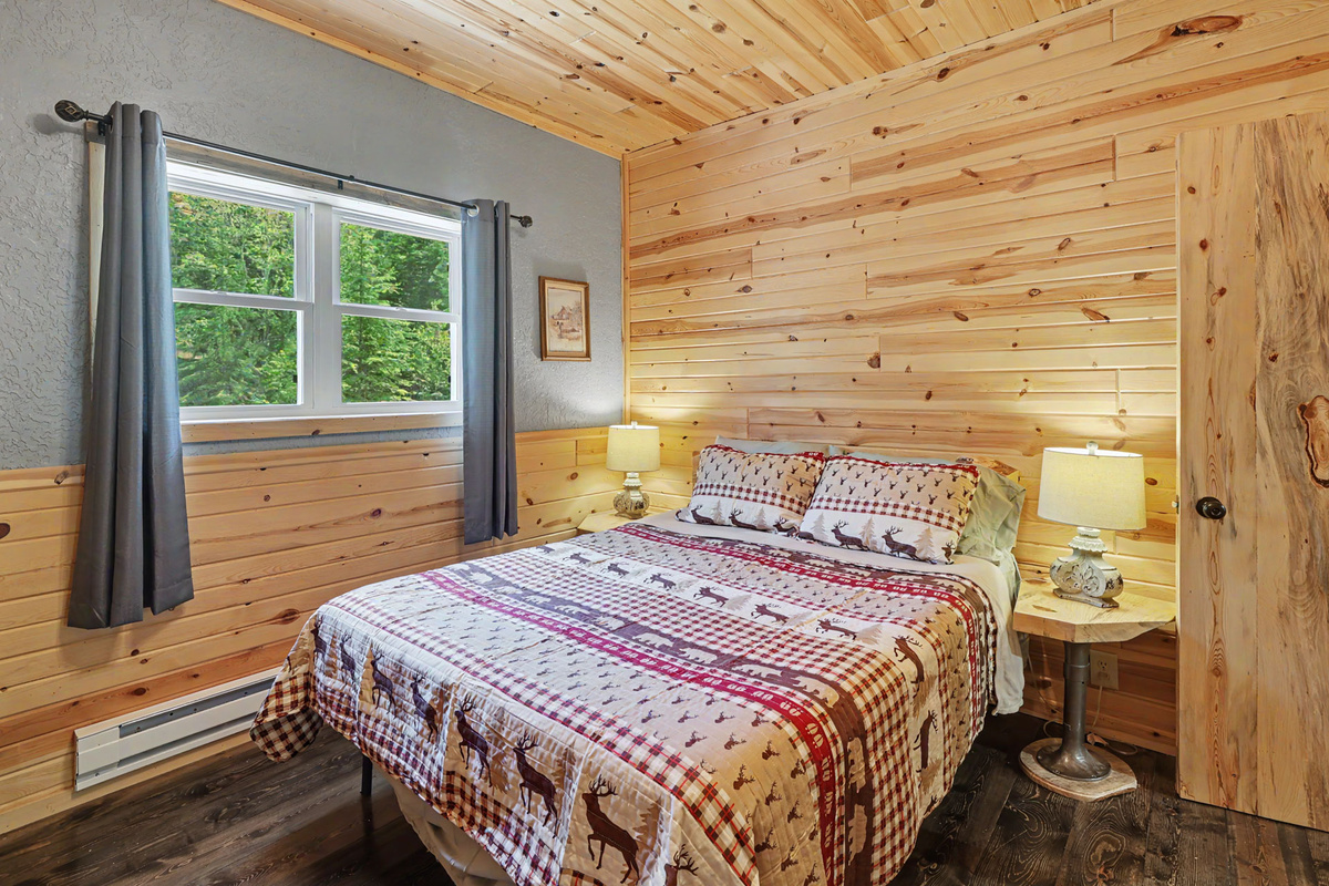 Main Floor Queen Bedroom with views of the yard and stream