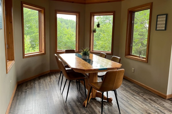 Dining for six around a beautiful river running wood table with panoramic view. 