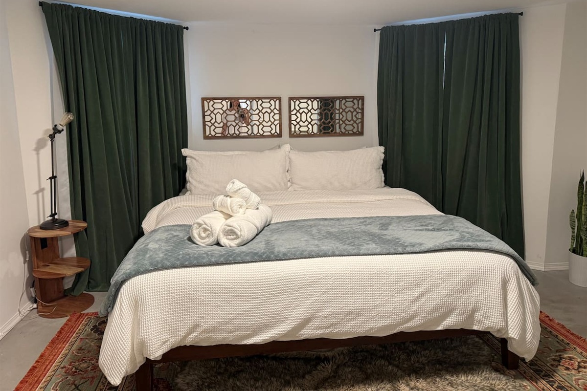 Comfortable King bedroom with plush bedding for a restful night's sleep.
