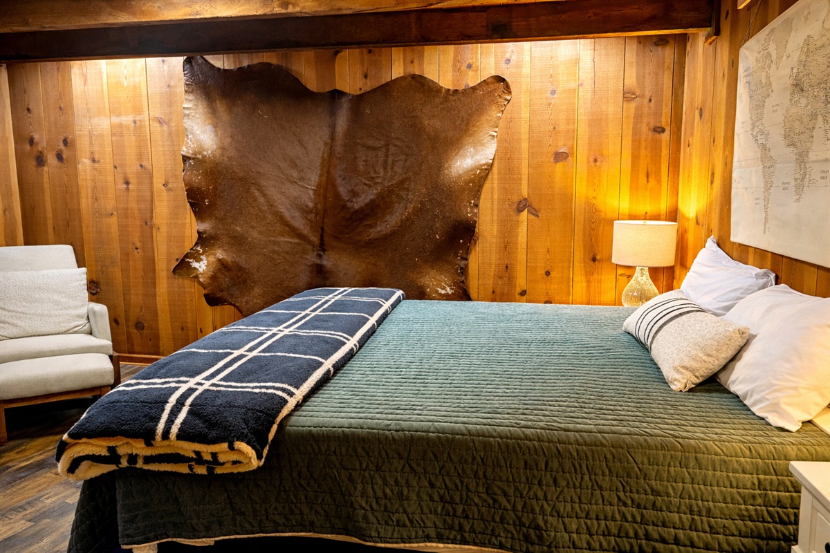 Plush bedding, warm lighting, and cozy cabin vibes make this bedroom the perfect place to recharge.