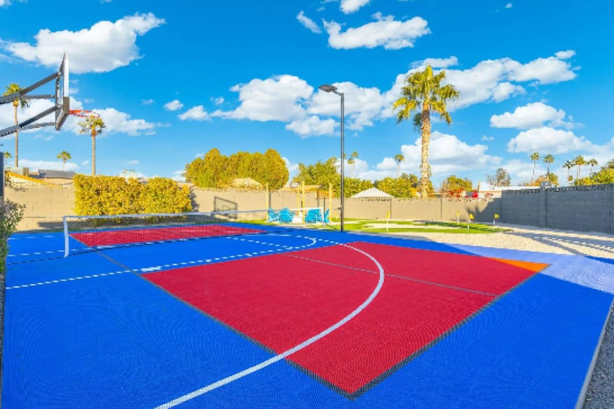Painted red and blue zones turn this court into a flexible space for basketball, volleyball, or pickleball.