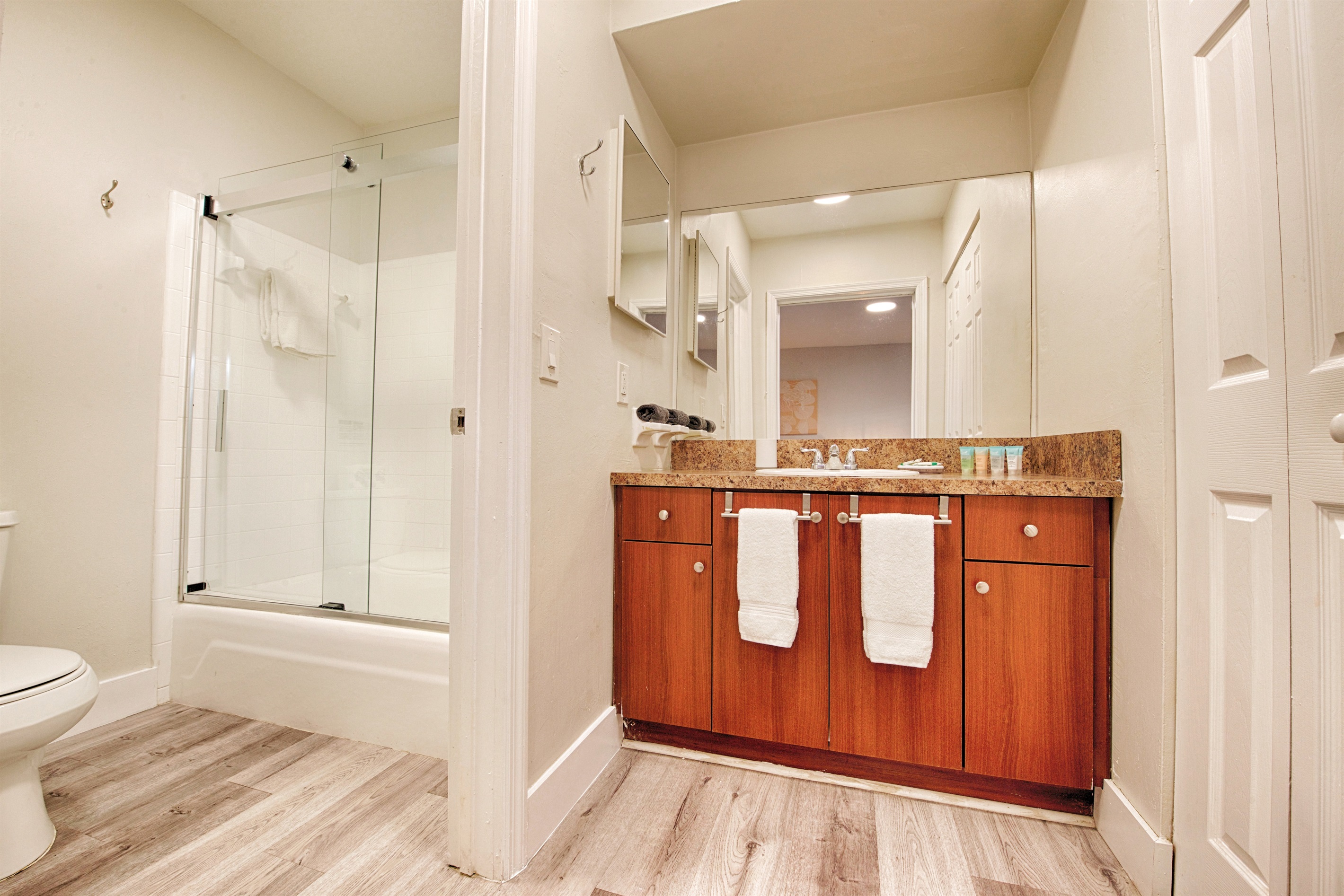 Bathrooms stocked with basic bath products, including body soap, shampoo, and conditioner.