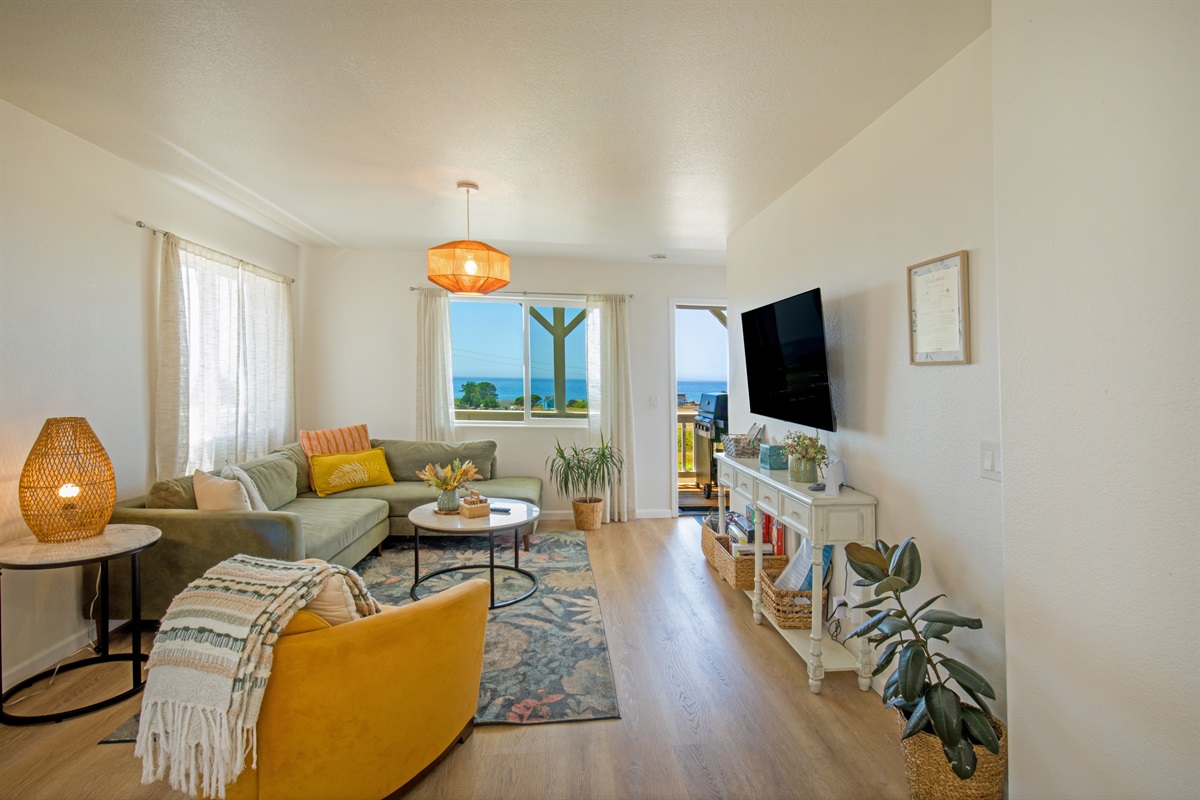 Seating area of Unit 1. Take in the beautiful ocean view as you relax on this comfortable couch