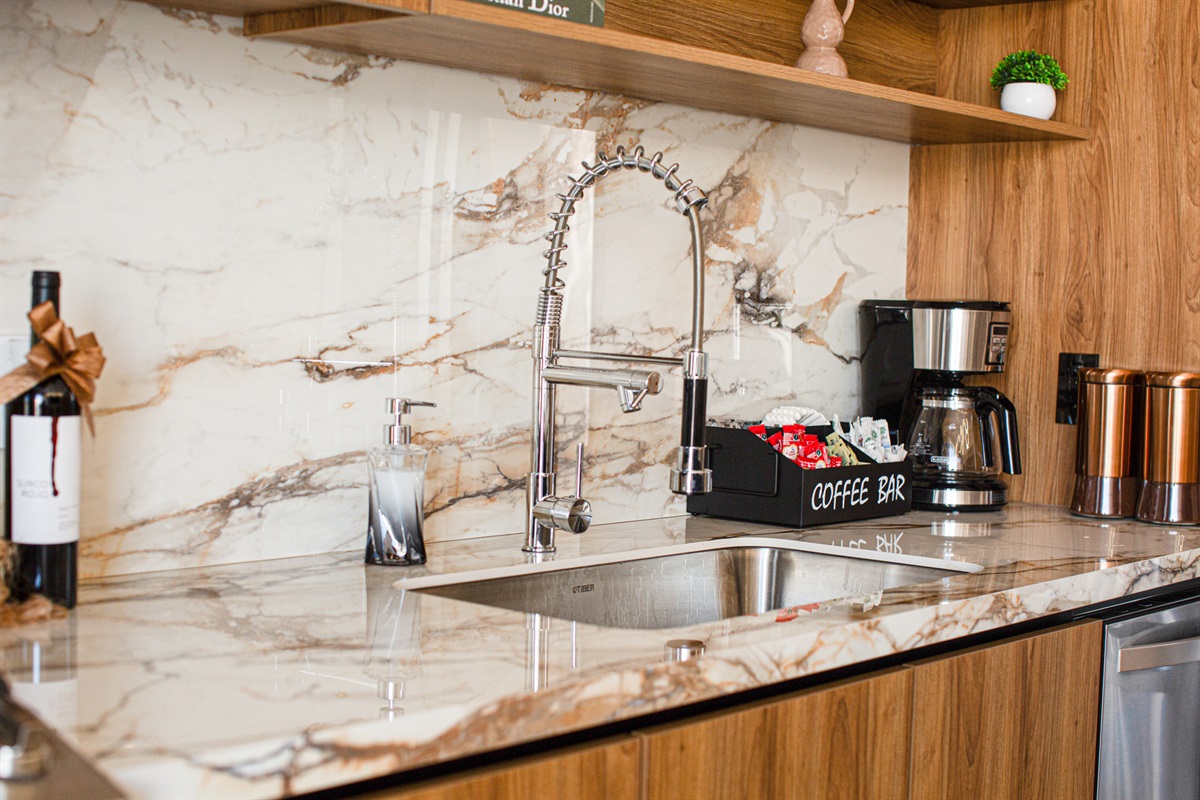 Your fully equipped kitchen includes a dedicated coffee bar, ideal for brewing your morning cup before exploring the Romantic Zone.