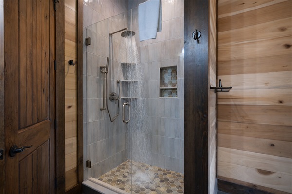A modern shower with beautiful tile work, offering a spa-like experience.