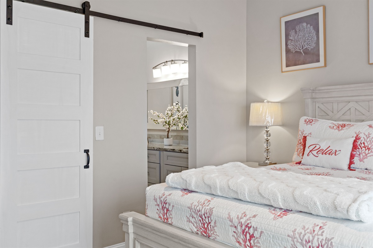 Private queen bedroom with stylish barn door and full bathroom access
