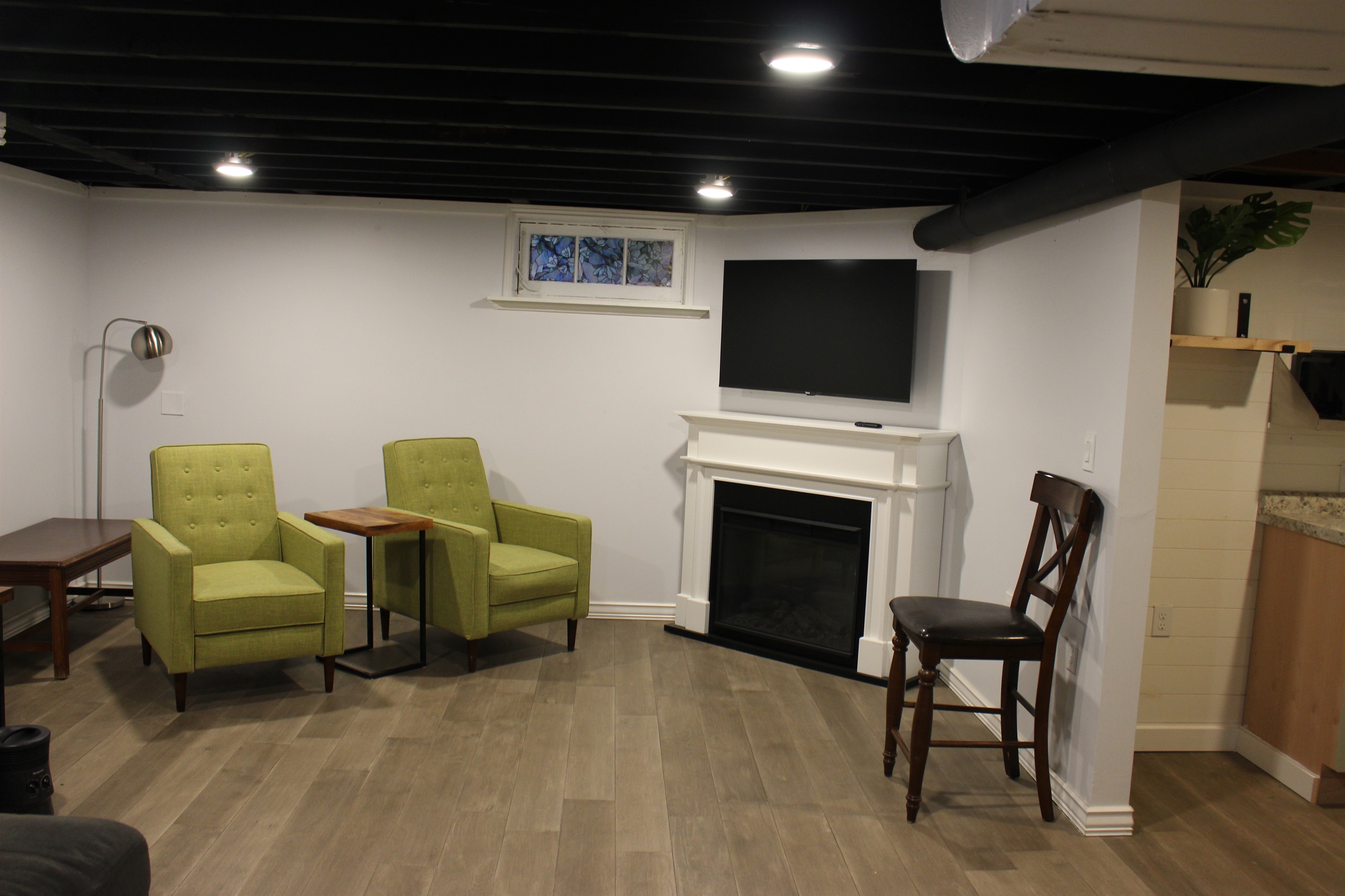 Basement seating area with TV and electric fireplace