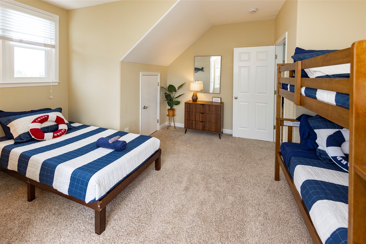 This 3rd floor room has one Twin bed with a set of Twin bunks, along with its own en suite bathroom