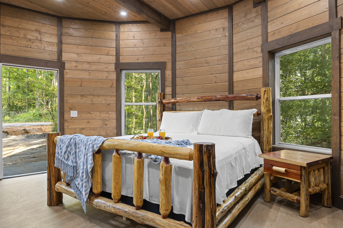 Bedroom Retreat: Experience rustic charm with stunning forest views and a handcrafted log bed!