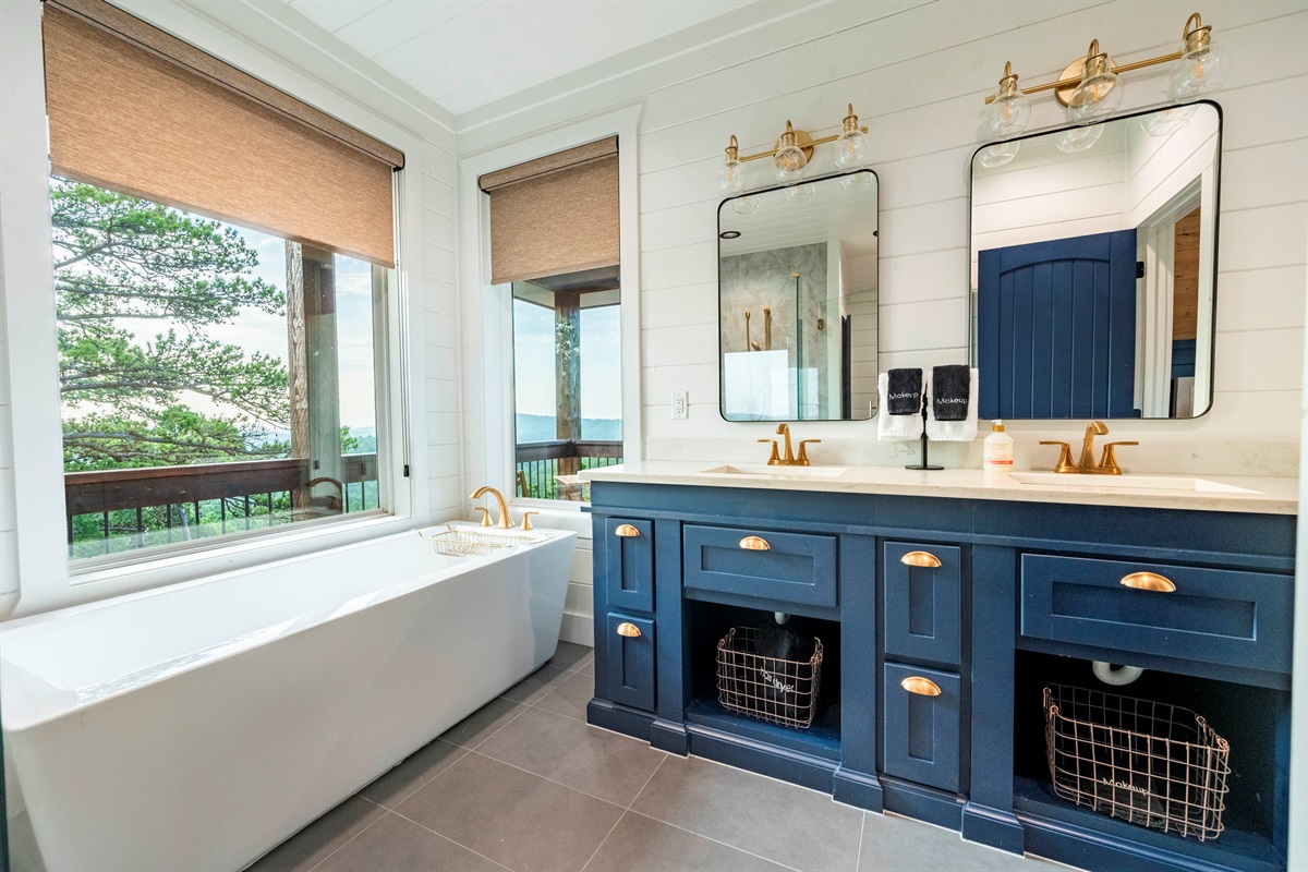 Bright and elegant bathroom with soaking tub and scenic outdoor views
