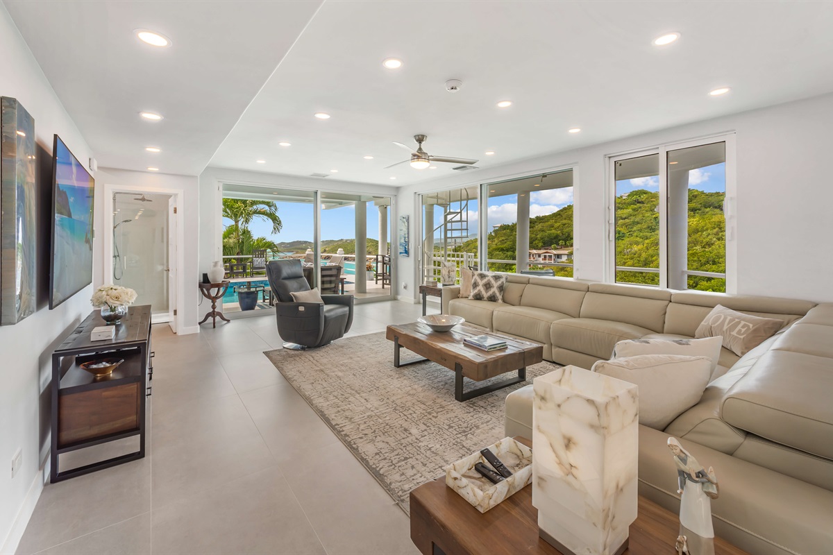 This spacious living room leads to the pool deck