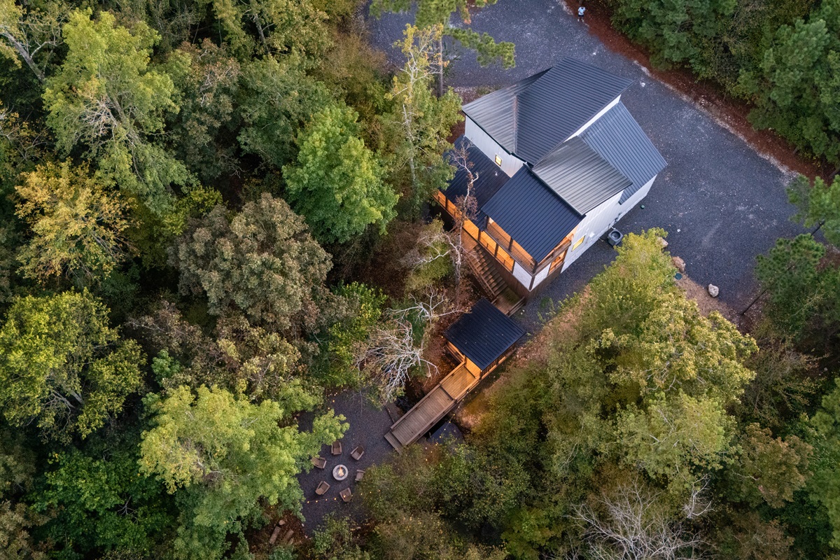 An aerial perspective reveals the cabin nestled among the trees, offering privacy and a true escape into nature.