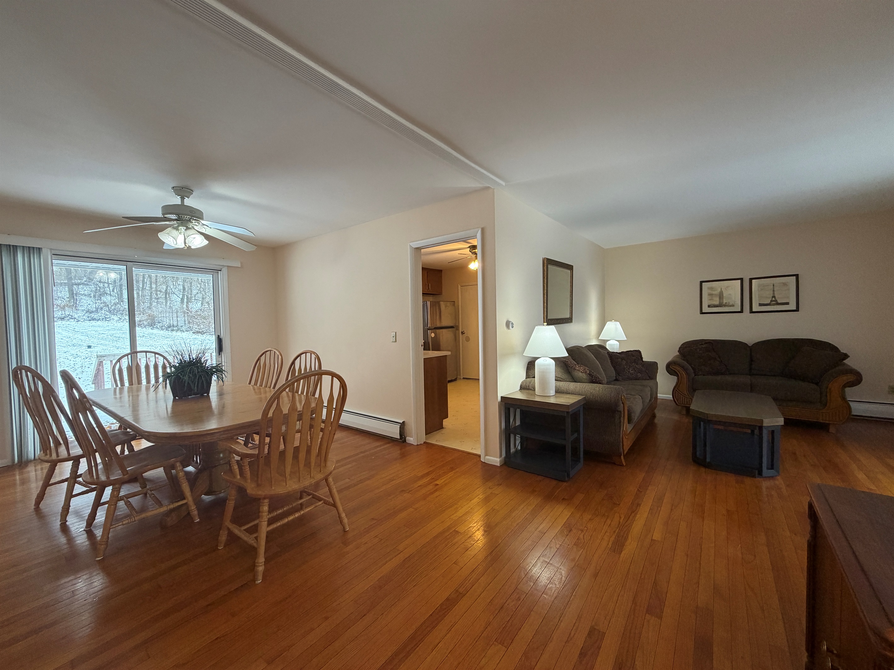 Open living and dining area with kitchen beyond