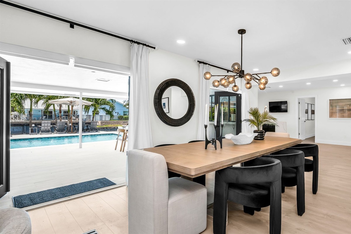 Experience resort-style dining with a designer table for 8 indoors and al fresco seating for 10 by the pool, offering an elegant backdrop for unforgettable gatherings