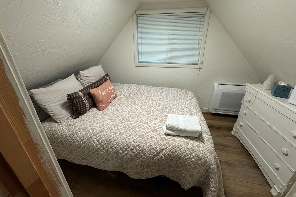 Curl up for a good night's sleep in this upstairs bedroom, featuring a snugly comforter and plenty of pillows. Drift off to sleep with the fun night light. Each bedroom has it's own thermostat with both heat and air. 
