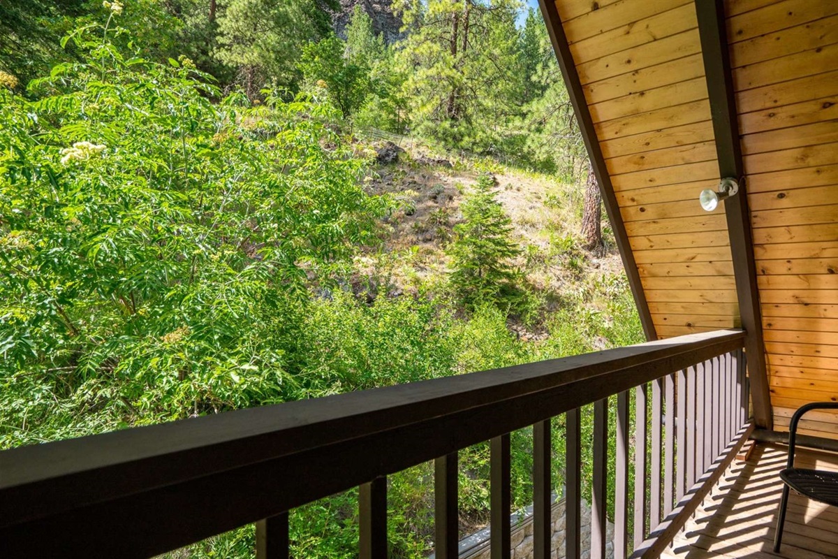 Private balcony overlooking the trees — the perfect morning coffee spot.