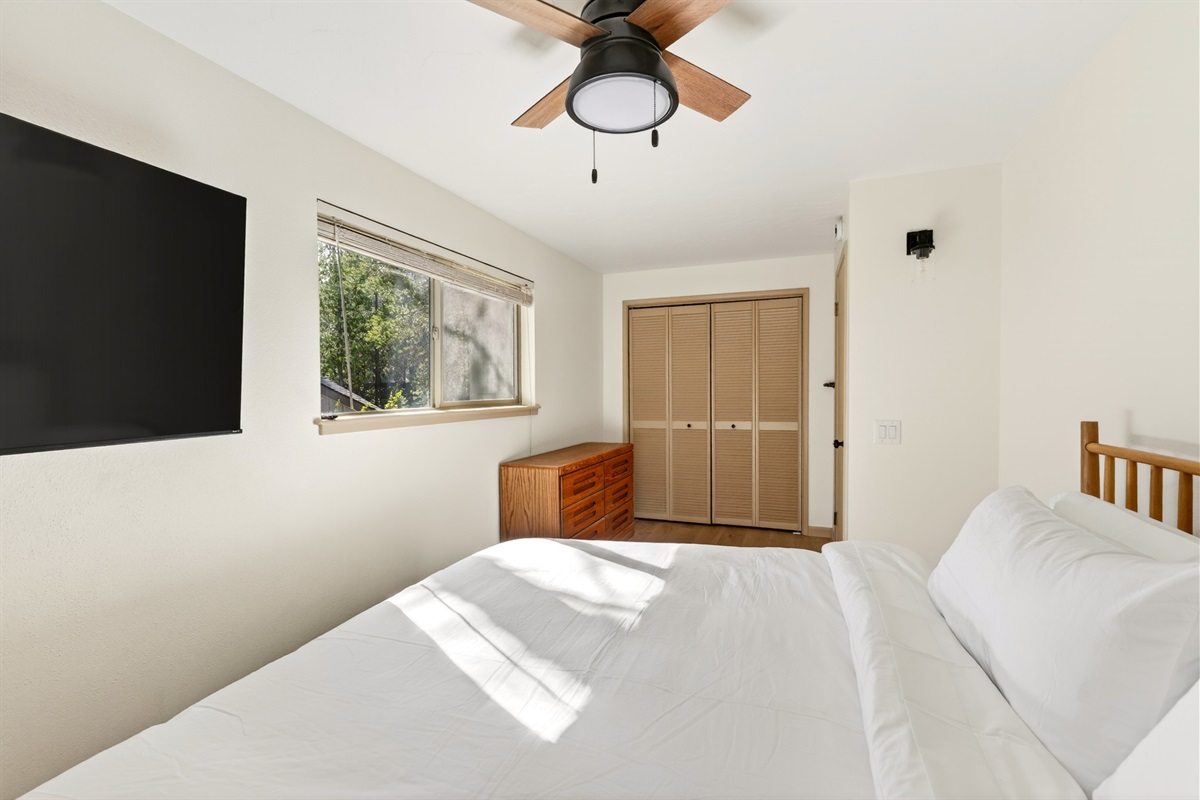 Upstairs Bedroom 2 features a comfortable king bed and Smart TV, offering a quiet, private retreat with elevated comfort.