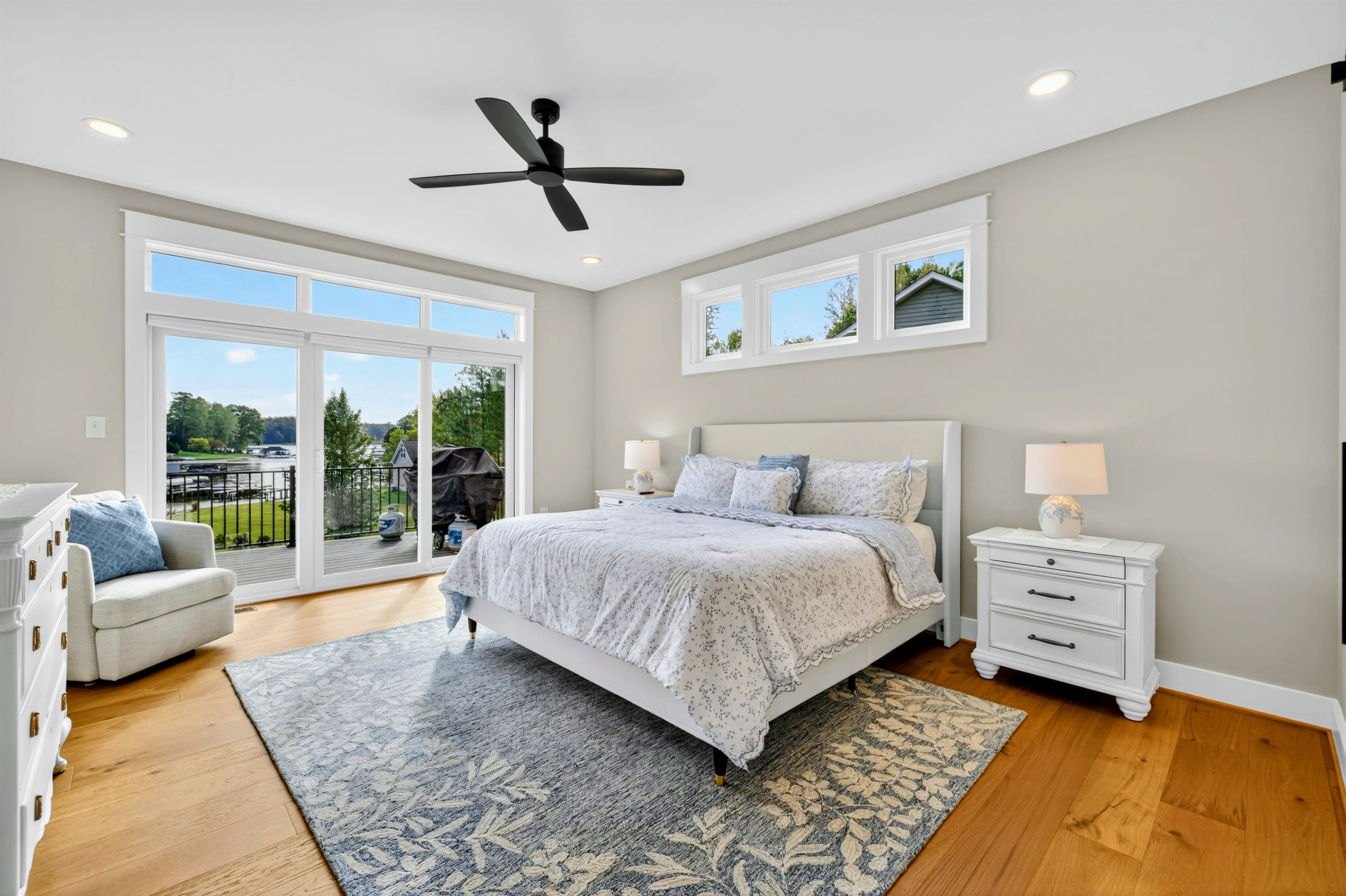 The main king suite is an indulgent retreat wrapped in layers of crisp whites and blues that mirror the tranquility of the lake, elevated with refined details, antique touches & plush bedding & feels like a private retreat where elegance meet serenity.