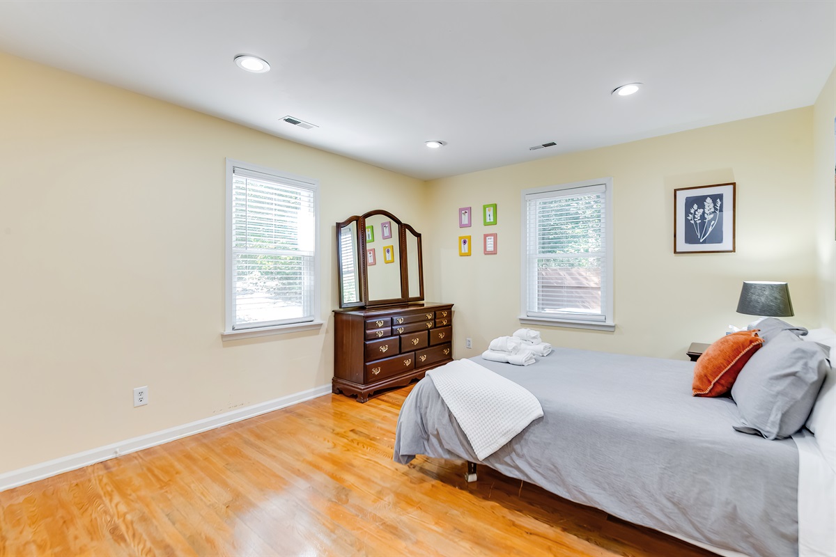 Upstairs Queen Bedroom 2: Enjoy warm sunlight and charming decor in your serene retreat!