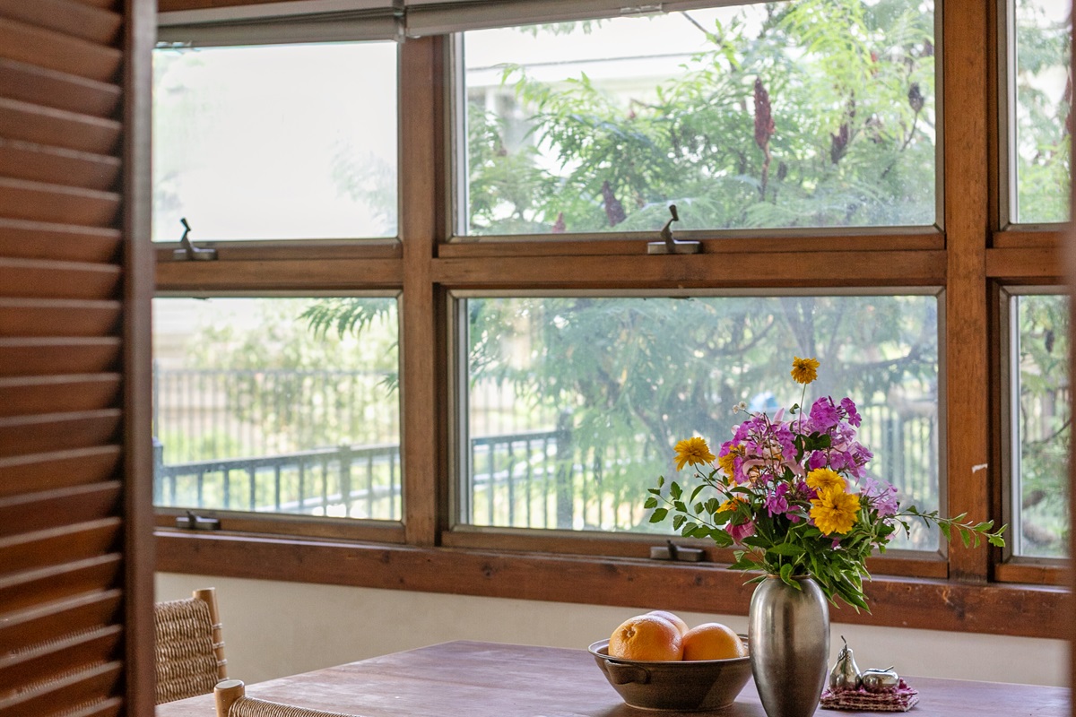 Sunlight pours across the dining table, creating a bright and inviting place to gather.