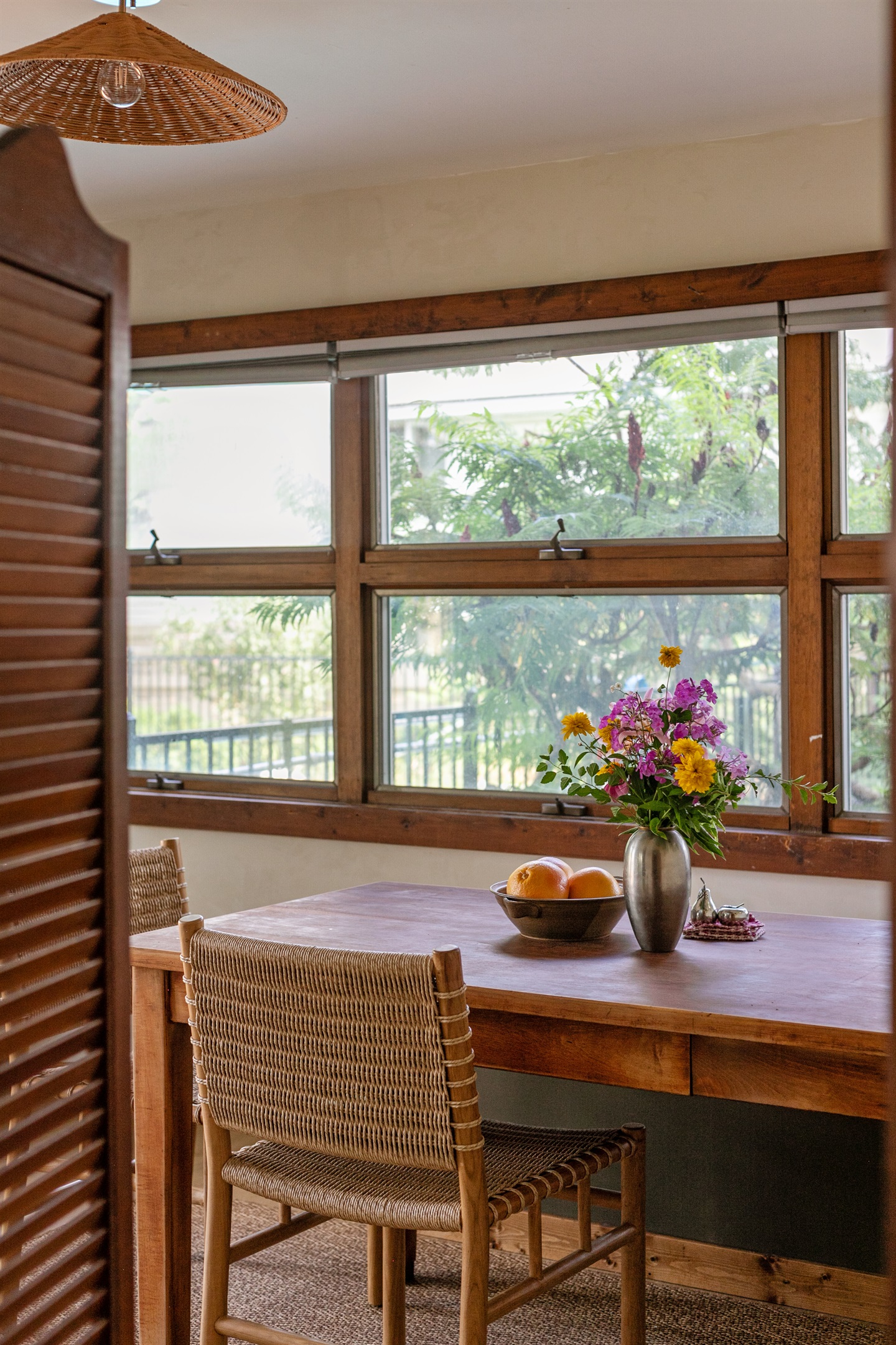 Sunlight pours across the dining table, creating a bright and inviting place to gather.