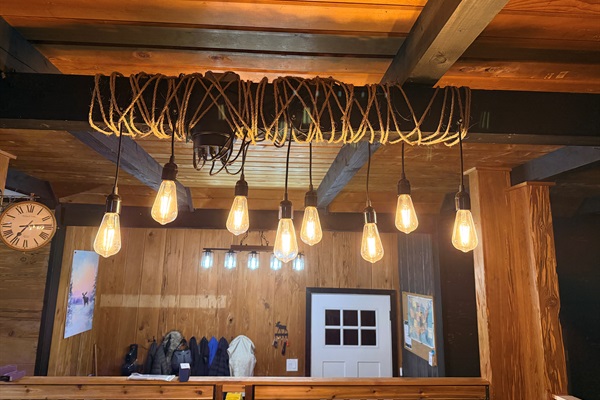 The dining area, with seating for everyone, overlooks the entryway. To the left, you'll see the stream outside the windows, and to the right, beyond the stone fireplace, you'll see Mt Argentine, one of Summit County's fourteeners!
