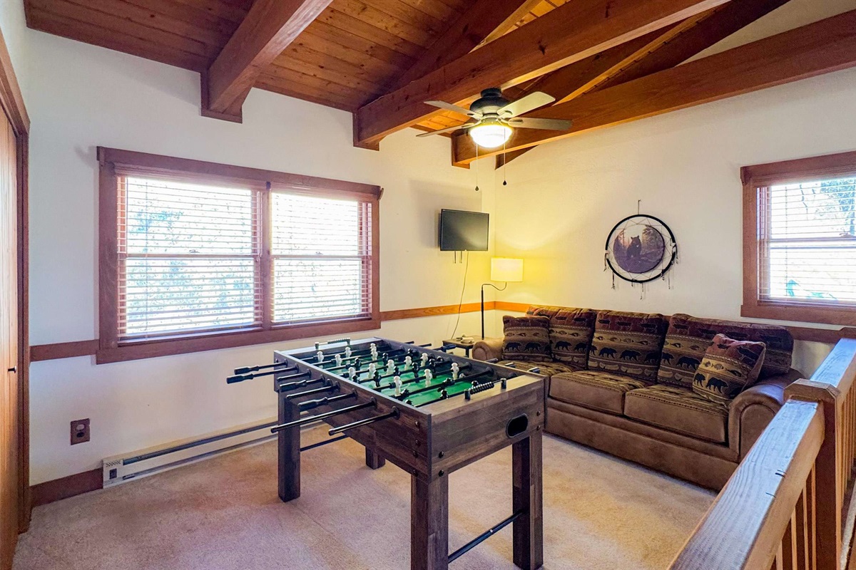 foosball and couch in the game room 