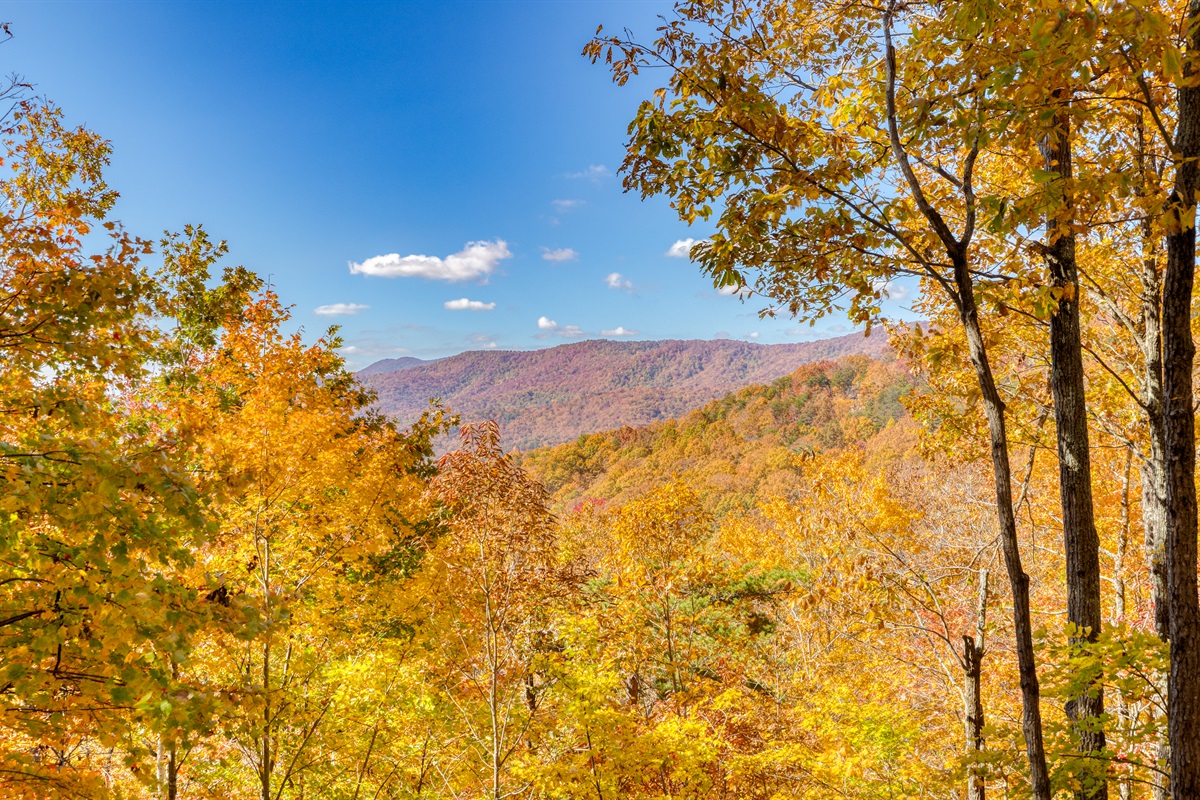 This is the view of the valley, mountains and sunset from our top level front porch, right by the front door.  This level of deck also has the gas grill, outdoor dining table, rocking chairs and swing.